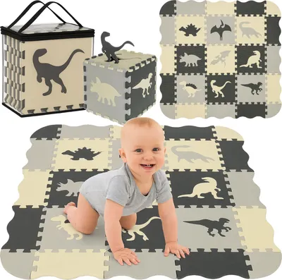 A baby is crawling on a play mat made of interlocking foam tiles with dinosaur designs. There is also a cube made of similar tiles and a storage bag in the background.