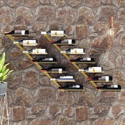 A stone wall with a modern, geometric wine rack holding several bottles of wine.