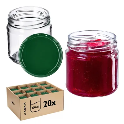 A collection of glass jars, some filled with jam, and a cardboard box containing more jars.