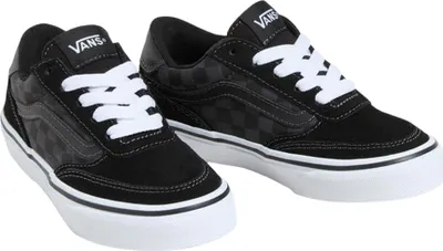 A pair of black Vans sneakers with white laces against a white background.