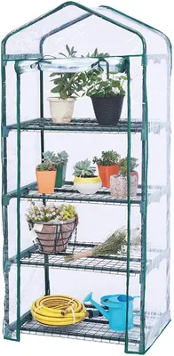 A mini greenhouse with multiple shelves filled with potted plants and gardening accessories.