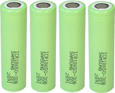 Four green lithium-ion batteries are lined up vertically against a white background.