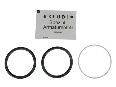 A packet of grease and three O-rings are displayed against a white background.