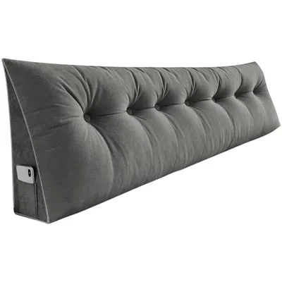 A gray triangular backrest cushion with button tufting and a side pocket for a phone.