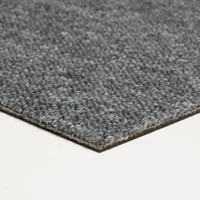 A close-up, angled view of a gray carpet tile.