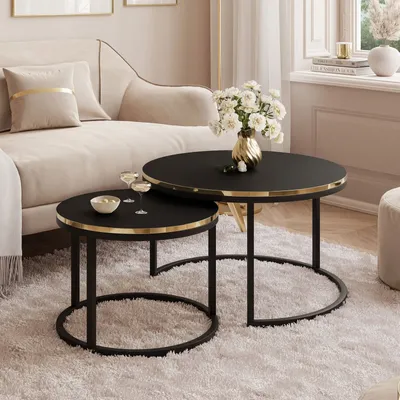 A living room scene with a sofa, coffee tables, and a vase of flowers.