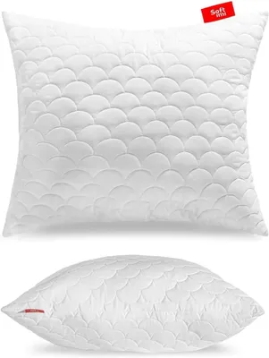 A white quilted pillow is shown from two angles against a white background.
