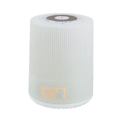 A white cylindrical alarm clock with a digital display showing the time.