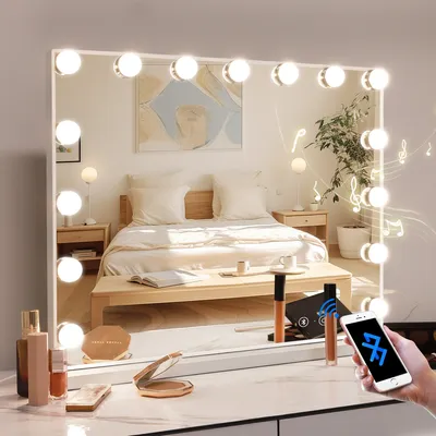 A vanity mirror with lights and a phone connected via Bluetooth, placed on a dresser in a bedroom.
