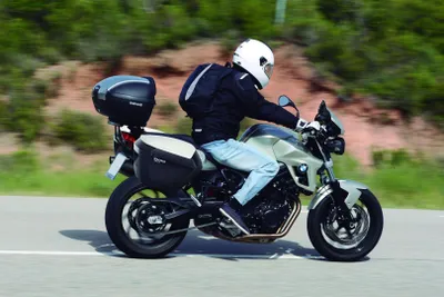 A person riding a motorcycle on a road.