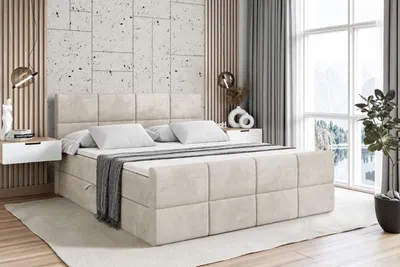 A bedroom scene featuring a large bed with storage, bedside tables, and a window with a view.