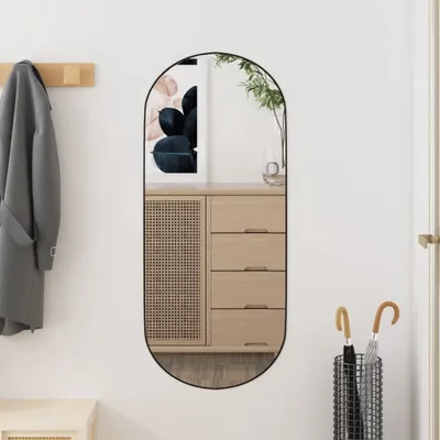A hallway with a mirror, coat rack, and umbrella stand.