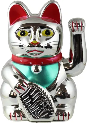 A silver Maneki Neko (lucky cat) figurine with red ears and collar, and a turquoise bib.