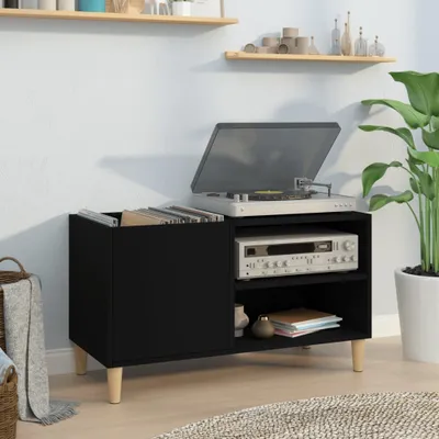 A black record cabinet with a turntable and receiver on top, placed in a room with shelves and a plant.