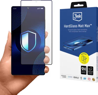 A hand holding a smartphone with a screen protector applied, next to the product's packaging.
