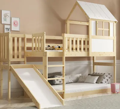 A wooden bunk bed with a slide and a house-like structure on top, set in a child's bedroom.
