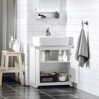 A white bathroom vanity with a sink and various bathroom accessories.