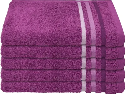 A stack of folded purple towels with decorative stripes on the edges.