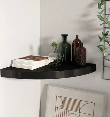 A black corner shelf mounted on a white wall, displaying books and decorative bottles.
