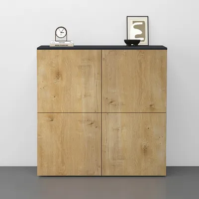A modern sideboard or kommode with a wood grain finish and a black top, displayed against a white wall and gray floor.