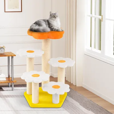 A cat is resting on a multi-tiered cat tree with flower-shaped platforms, placed indoors near a window.