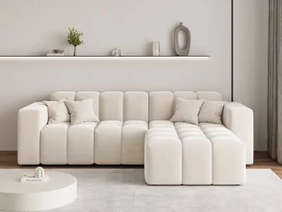 A modern living room scene featuring a cream-colored sectional sofa.