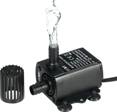 A black DC brushless water pump with water spraying from the outlet, shown with a separate filter attachment.