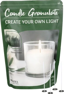 A bag of candle granules with a demonstration of a candle made from the granules in a glass.