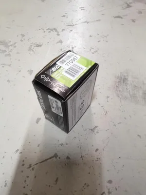 A black and green product box is shown on a concrete floor.