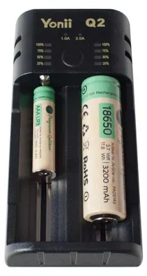 A close-up of a battery charger with two batteries inserted.