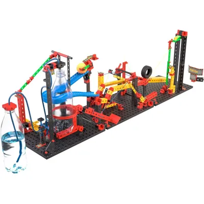 A complex construction toy set with multiple interconnected parts, including bottles, tubes, ramps, and wheels, arranged on a black base.