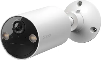 A white security camera with a black front panel and lens, mounted on a white circular base with screws.