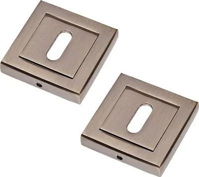 Two square door escutcheons with keyholes, presented on a white background.