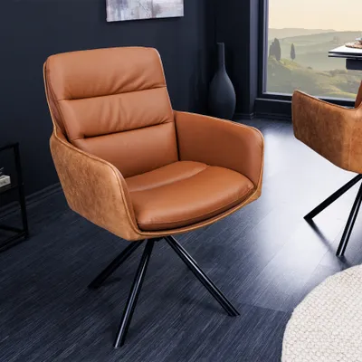 A brown leather swivel chair with a black base is shown in a room with a dark wall and a window with a landscape view.