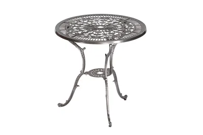A single round table with an ornate, openwork design on the tabletop and legs, isolated on a white background.