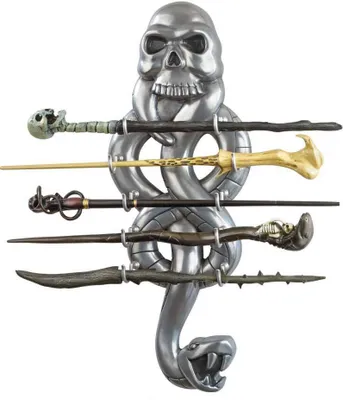 A collection of Harry Potter wands displayed on a stand shaped like a skull and snake.
