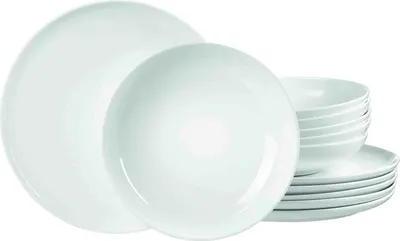 A set of white ceramic plates and bowls stacked together.
