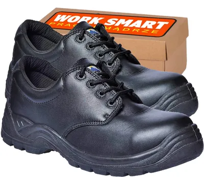 A pair of black safety shoes with a cardboard box in the background.