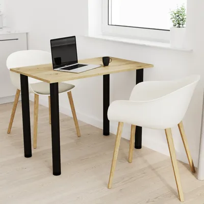 A modern dining set with a wooden table and two white chairs in a bright room with a window.