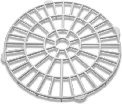 A white plastic grid insert for a canning machine.