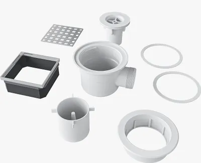 A collection of white and gray plumbing components, likely for a shower drain system, arranged on a white background.