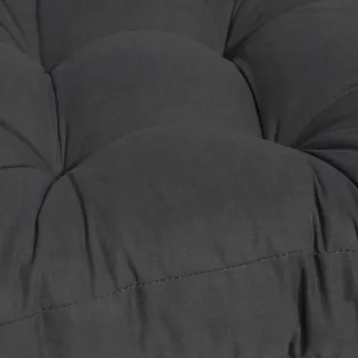A close-up view of a dark gray tufted cushion.