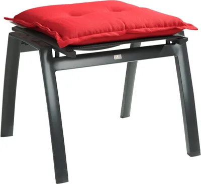A red cushion on a gray stool.