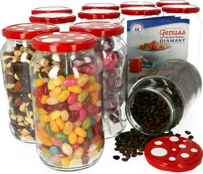 A collection of glass jars filled with various candies and nuts, with one jar of coffee beans spilled on the side.