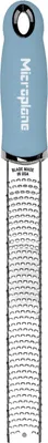 A close-up, top-down view of a Microplane grater against a white background.