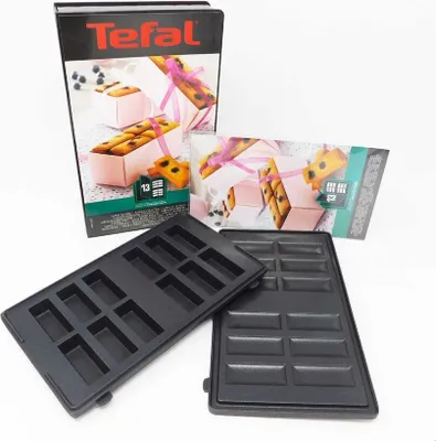 A Tefal snack maker with its packaging and molds are displayed against a white background.