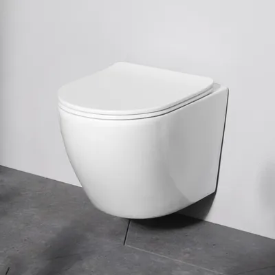 A white wall-mounted toilet is shown against a white wall and a gray tiled floor.