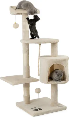 Three kittens playing on a multi-level cat tree.