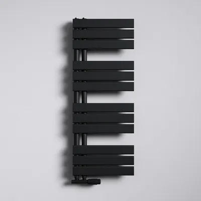 A black radiator is mounted on a white wall.