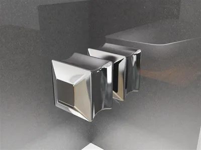 A close-up view of two chrome shower knobs against a dark gray textured background.